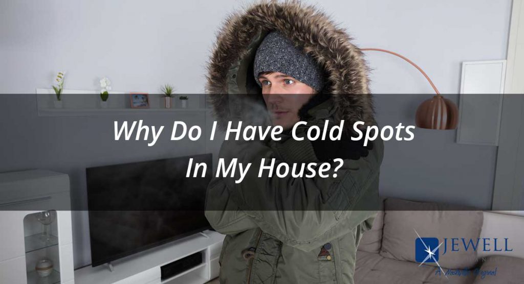 A man is cold inside his house due to cold spots.